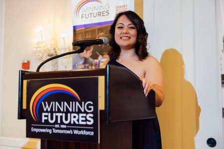 winning futures student at podium