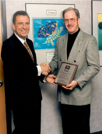 Sam Cupp receiving Mentor of the Year Award from Floyd Wickman